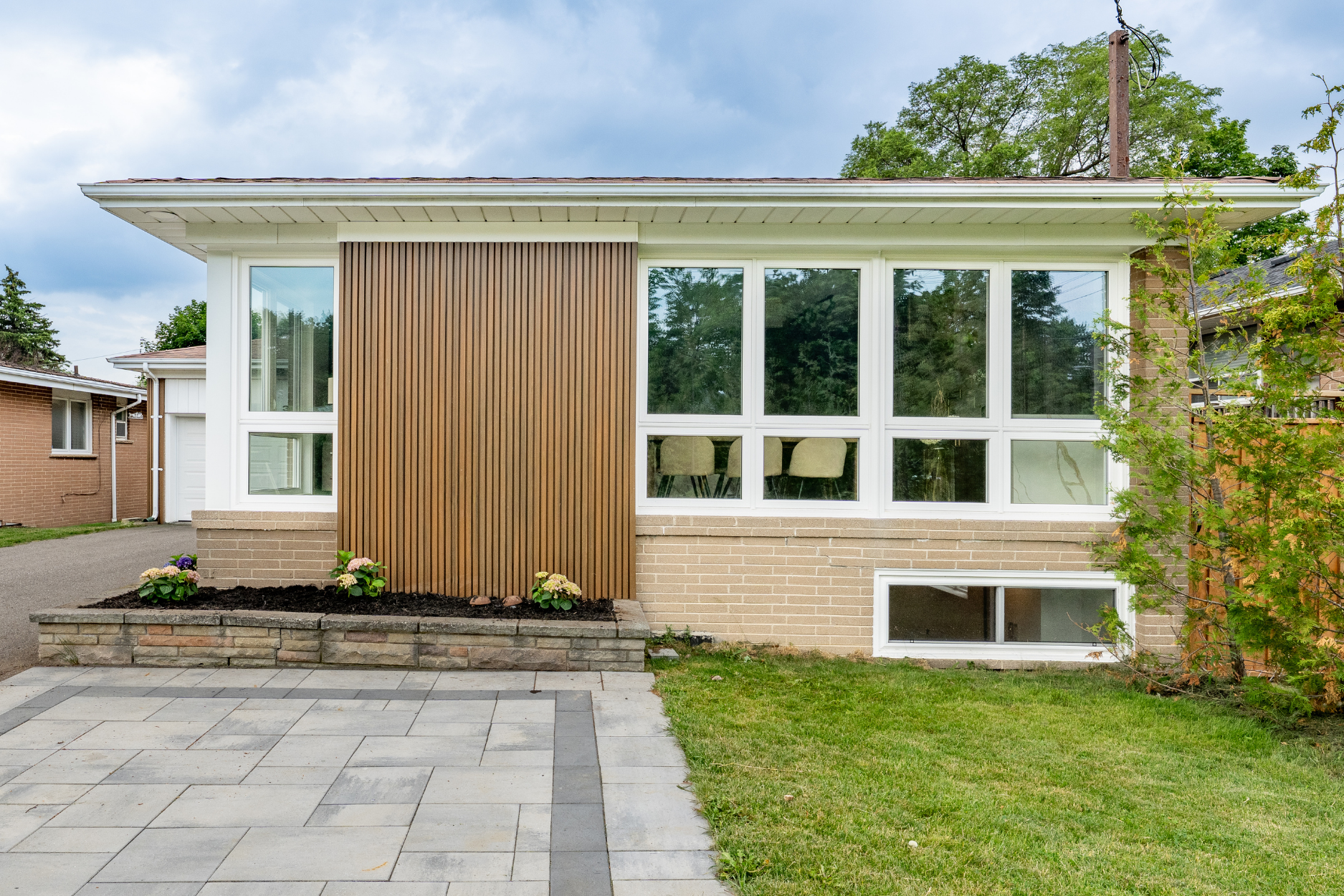 Illuminated concrete and glass facade of the home