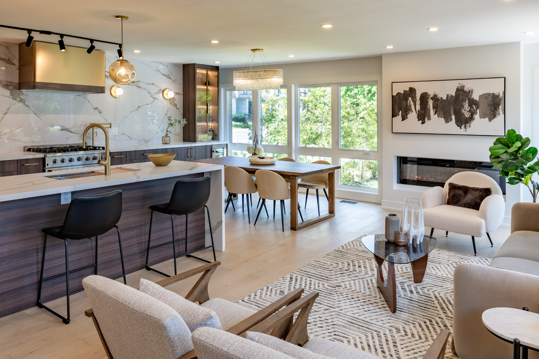 Living room with a marble fireplace, white sofas, and dark wood shelving
